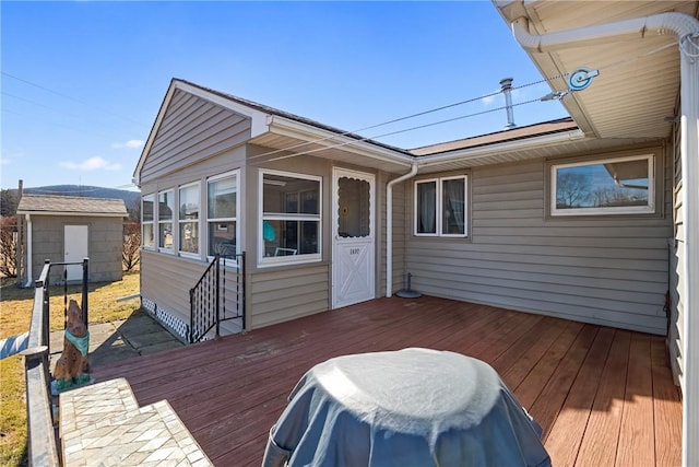 deck with an outbuilding and a storage shed