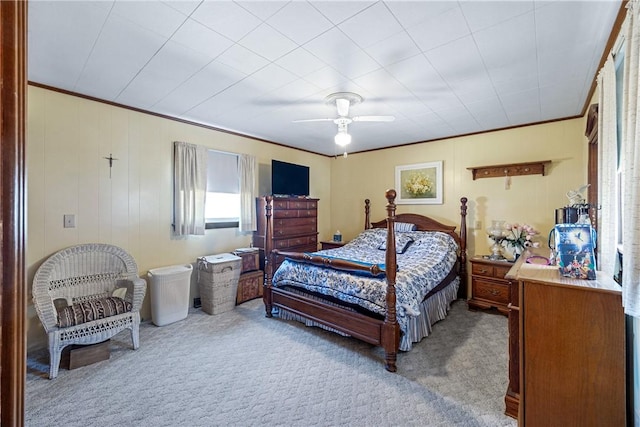 carpeted bedroom with crown molding and ceiling fan