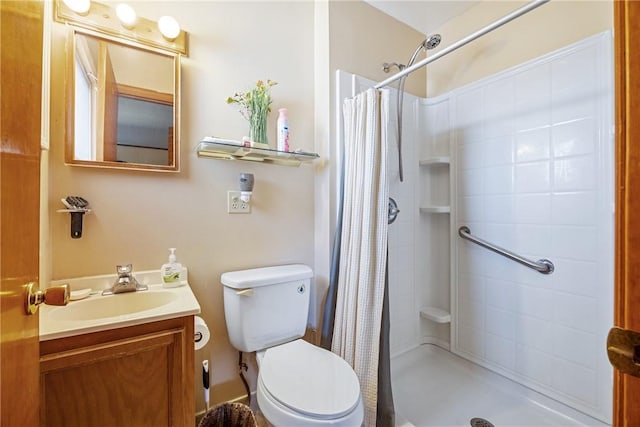 full bathroom with toilet, a stall shower, and vanity