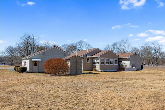 rear view of property featuring a yard