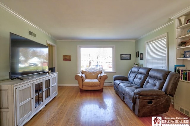 living area featuring a baseboard heating unit, ornamental molding, visible vents, and light wood-type flooring