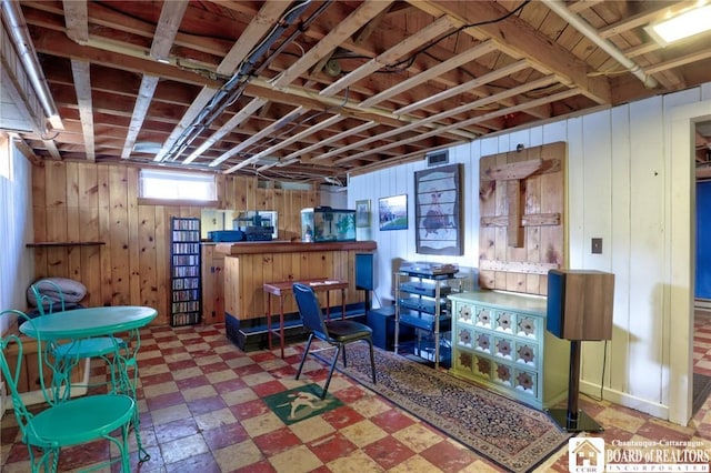 interior space featuring tile patterned floors and wooden walls