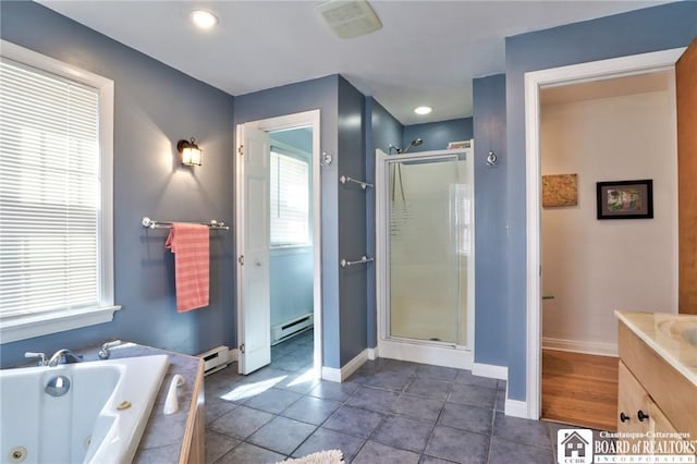 bathroom with a baseboard heating unit, a shower stall, and a whirlpool tub