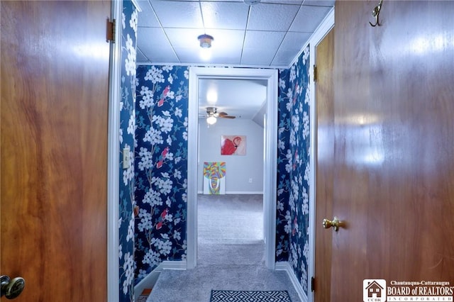 bathroom with wallpapered walls and baseboards