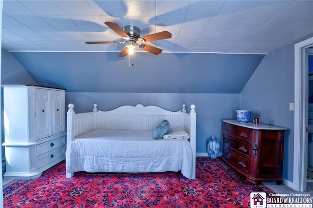 bedroom with baseboards, lofted ceiling, a ceiling fan, and carpet flooring