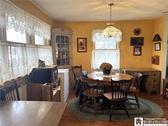 dining area with a wealth of natural light and wood finished floors