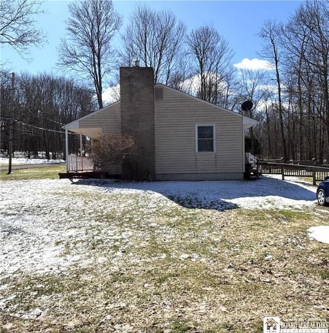 view of property exterior with a chimney