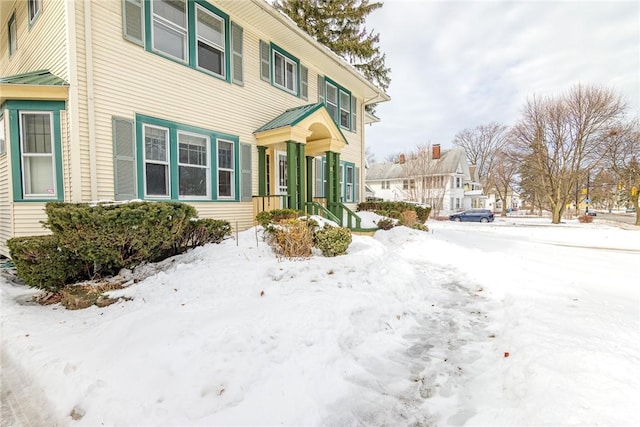 view of snowy exterior with a residential view