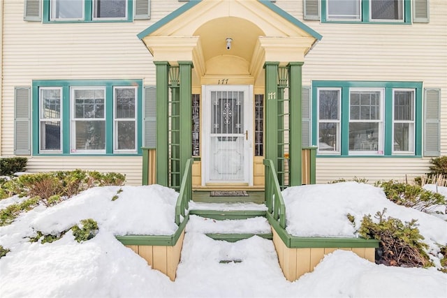 view of snow covered property entrance