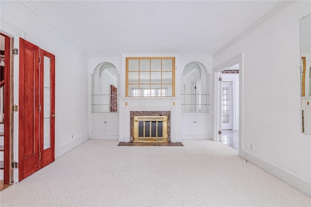 unfurnished living room featuring crown molding, carpet flooring, a fireplace, and baseboards