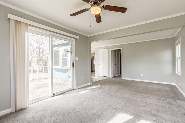 carpeted empty room featuring baseboards and ornamental molding