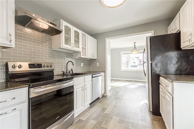 kitchen featuring white cabinetry, under cabinet range hood, appliances with stainless steel finishes, and a sink