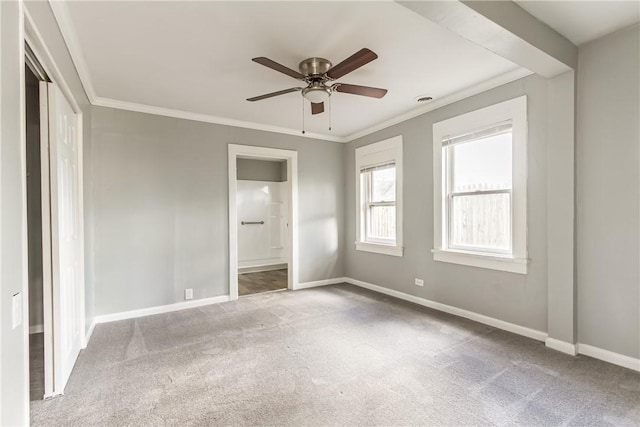 unfurnished bedroom with baseboards, carpet floors, connected bathroom, and crown molding