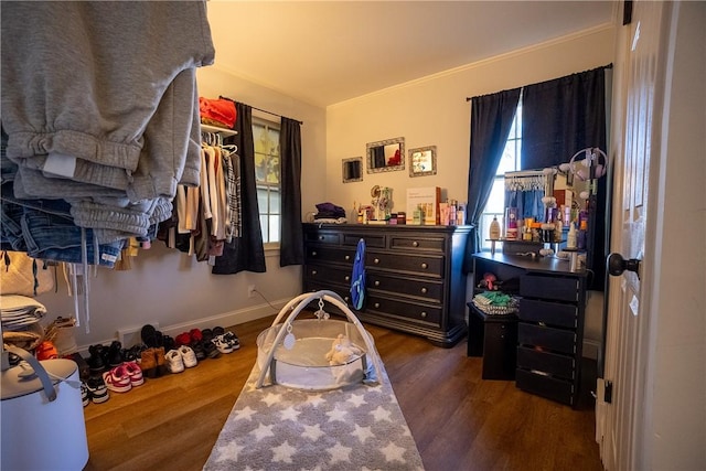 bedroom with wood finished floors and baseboards