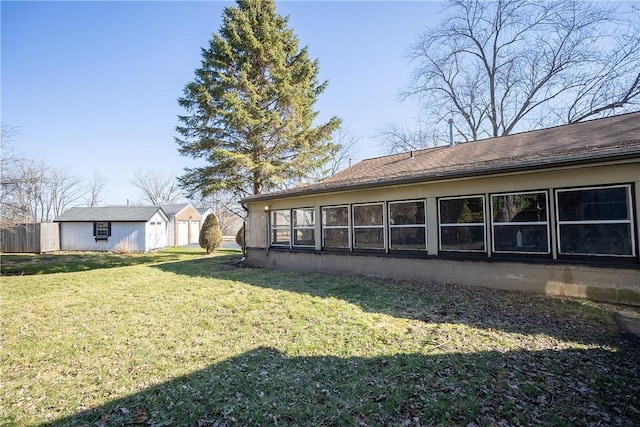 back of property featuring an outbuilding and a yard