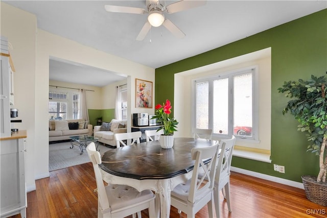 dining area with hardwood / wood-style floors, baseboards, and ceiling fan