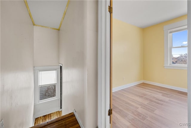 interior space with wood finished floors and baseboards