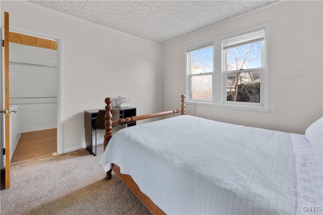 carpeted bedroom featuring baseboards