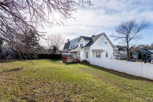 view of yard featuring a wooden deck and a fenced backyard