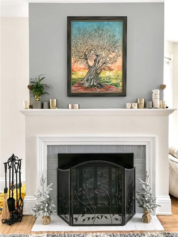 interior details with wood finished floors and a fireplace