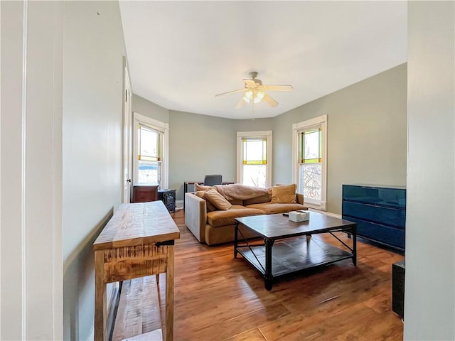 living room with light wood-style flooring and a ceiling fan