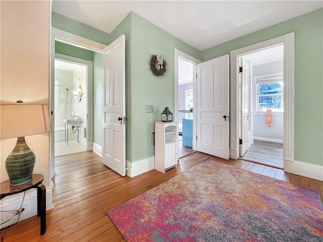 interior space with baseboards and wood-type flooring