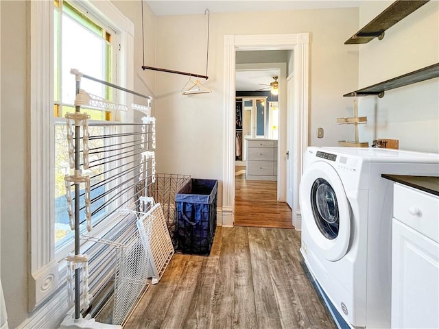 laundry room featuring cabinet space, washer / clothes dryer, and wood finished floors