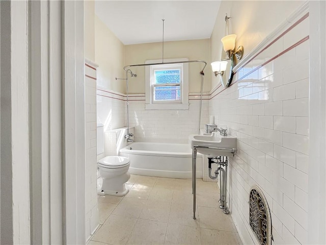 full bath with tile patterned floors, toilet, tile walls, and bathtub / shower combination