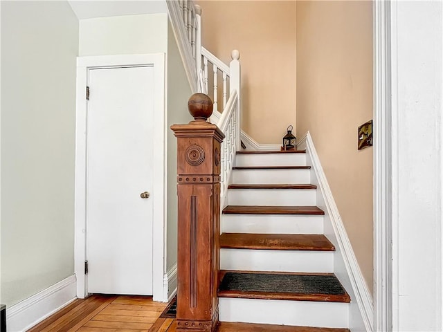 stairway with baseboards and hardwood / wood-style floors