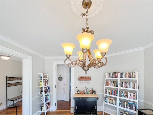 room details with crown molding, a notable chandelier, and wood finished floors