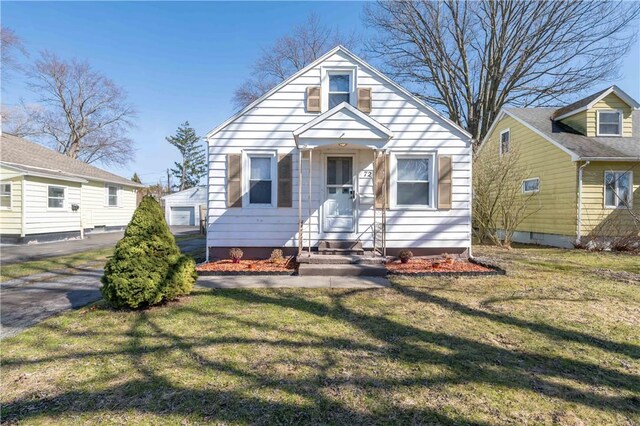 bungalow-style home with a front yard