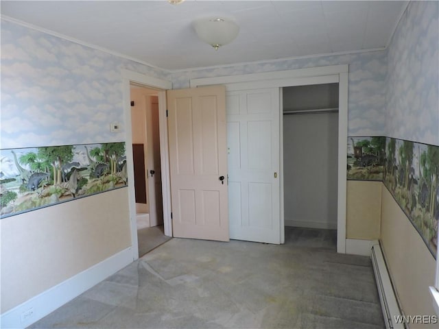 unfurnished bedroom featuring a baseboard heating unit, a closet, ornamental molding, and wallpapered walls