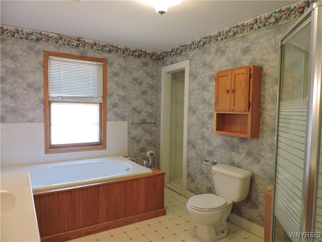 bathroom with wallpapered walls, a shower stall, a garden tub, toilet, and tile patterned floors