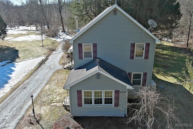 exterior space featuring a shingled roof