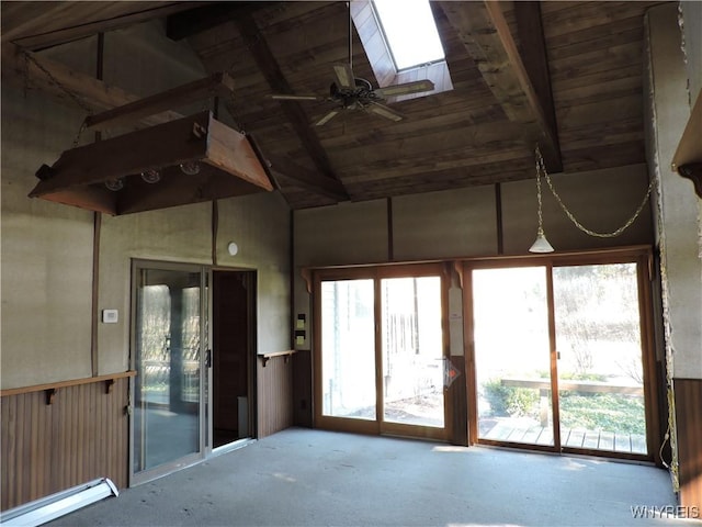 unfurnished sunroom with a baseboard heating unit, plenty of natural light, wood ceiling, and vaulted ceiling with skylight