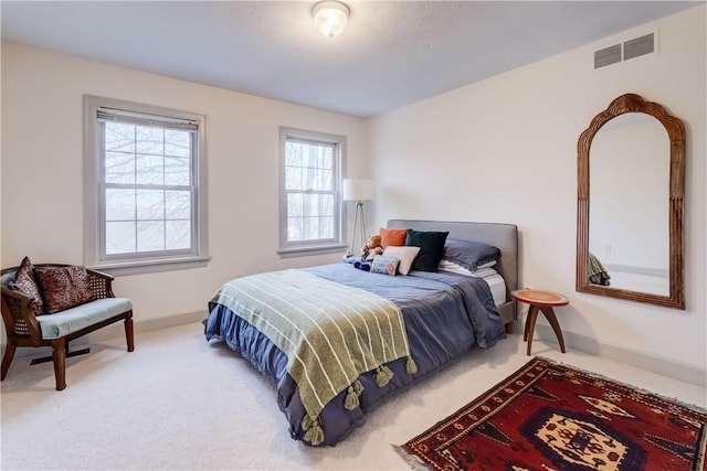 bedroom featuring baseboards, visible vents, and carpet floors