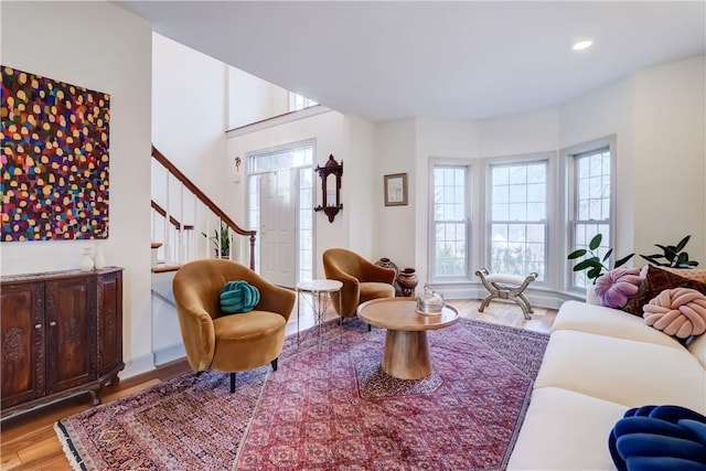 living room with stairs, recessed lighting, and wood finished floors