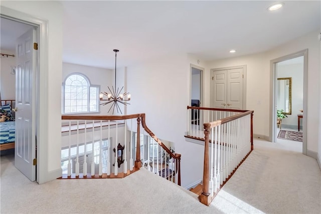 corridor featuring baseboards, a chandelier, an upstairs landing, carpet flooring, and recessed lighting