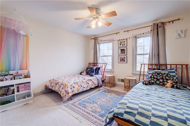 carpeted bedroom featuring visible vents and ceiling fan