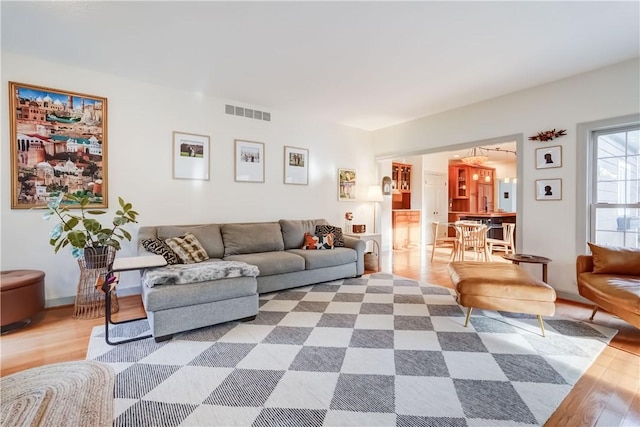 living room featuring visible vents and wood finished floors