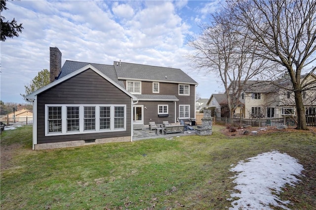 back of property featuring a yard, a chimney, a patio, and fence