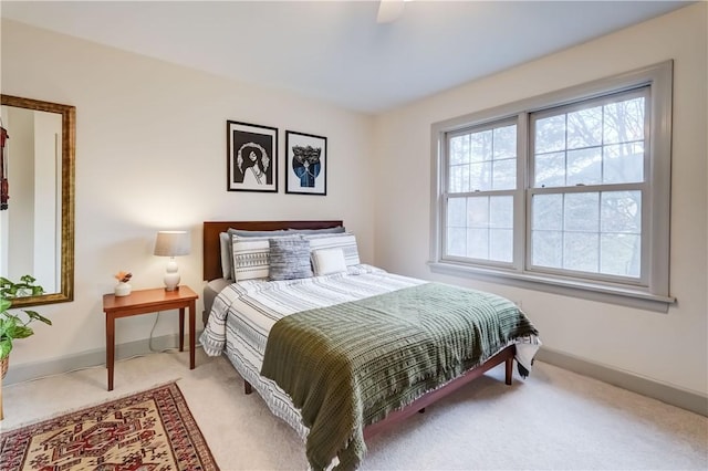 bedroom with baseboards, light colored carpet, and ceiling fan