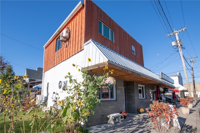 view of home's exterior with board and batten siding and metal roof