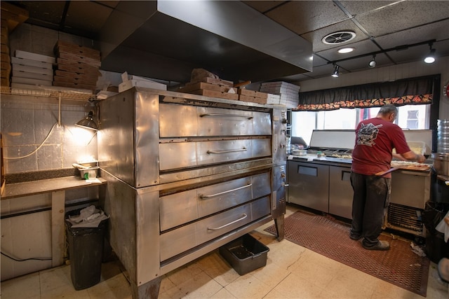 kitchen with track lighting, light floors, and visible vents