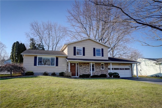 split level home featuring aphalt driveway, a garage, and a front yard