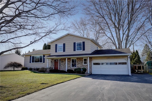 split level home with a front yard, a garage, and driveway