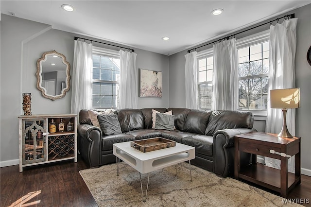 living room with recessed lighting, baseboards, and dark wood-type flooring