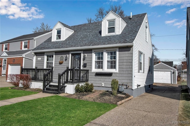 view of front of house featuring a garage, an outdoor structure, concrete driveway, and a shingled roof