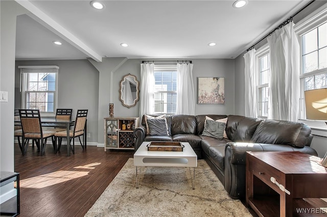 living area with beam ceiling, recessed lighting, dark wood-type flooring, and baseboards