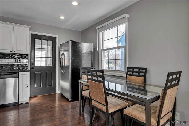 dining space with dark wood finished floors and recessed lighting